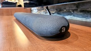A close up of the Bluesound Pulse Mini soundbar on a wooden surface